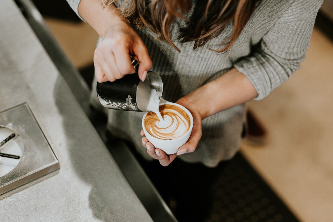 Artisan coffee preparation in a minimalist Singapore café setting