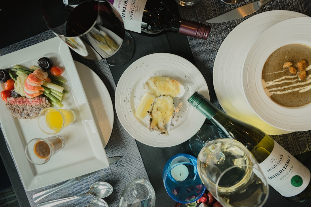 Elegant dining table with beautifully plated cuisine in warm restaurant lighting